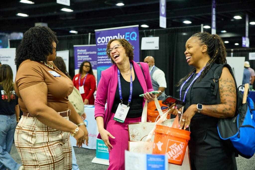 HR Southwest attendees laughing together in the expo hall