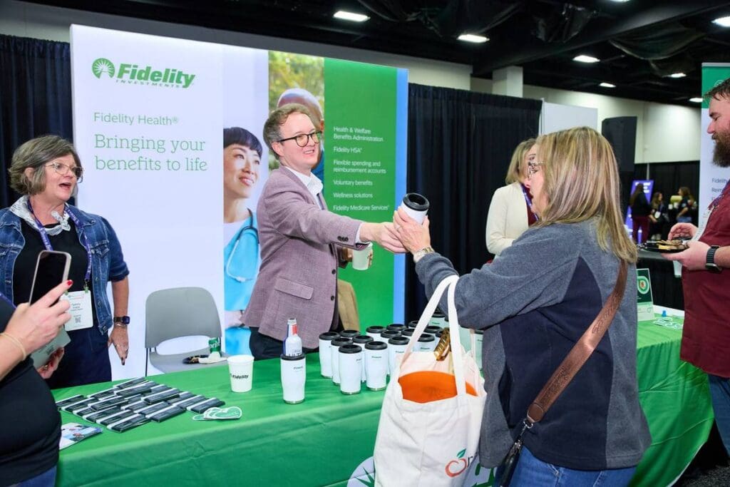 Attendees visiting a sponsor booth at HR Southwest